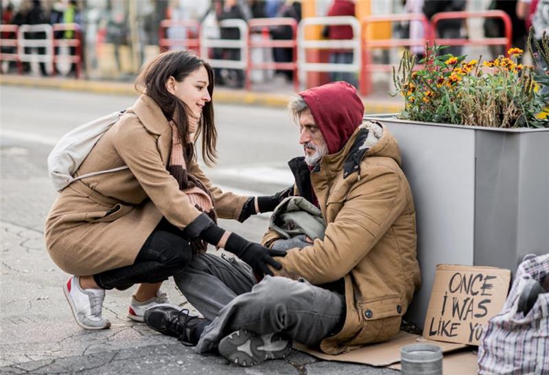 peer services for unhoused - woman helping an elderly in the street